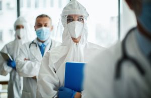 Doctors and nurses standing and looking at camera in the hospital.